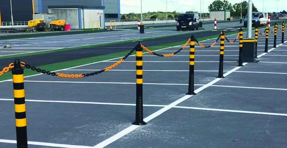 black and yellow chain barrier with bollards